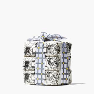 3 beekman 1802 Ylang Ylang & Tuberose 3.5 oz goat milk soaps stacked on top of each other, wrapped in gingham bow, on a white background. 