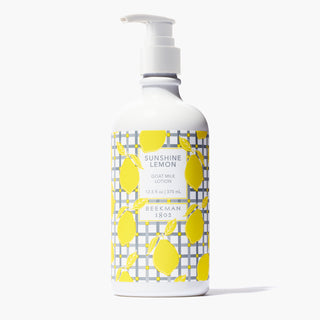 Bottle of Beekman 1802's Sunshine Lemon Goat Milk Lotion with white nozzle standing on a white background.