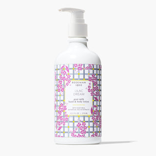 white Bottle of Beekman 1802's Lilac Dream Lotion with with gingham label designed with lilac flowers and a white nozzle on top, standing on a white background.