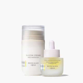 Bottle of Beekman 1802's Bloom Cream Daily Moisturizer and Collagen Booster electric Daisy & Peptide Firming Serum standing next to each other on a white background.