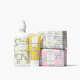 Products from Beekman 1802's B. My Baby Bodycare Bouquet bundle which includes a garden of gardenia hand and body wash, sunshine rose hand cream, jasmine bloom bar soap, and peony blush bar soap, all standing together on a white background. 