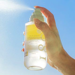 Milk Shake bottle misting on air with blue sky background