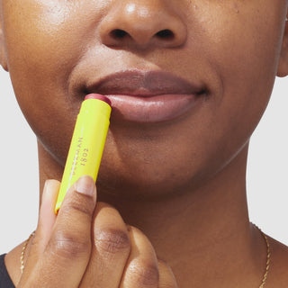 An up close video of a model applying the beekman 1802 Honeyed Grapefruit Sheer tinted Lip Balm to their lips.