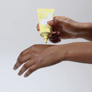 Hand squeezing Beekman 1802's Vegan Goat Milk™ Shine Control Gel Cream Moisturizer product onto their other hand, then rubbing the product into their skin, on a white background. 