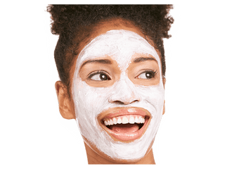 Headshot of model's face while they're smiling and looking off to the side and wearing Beekman 1802's Milk Mud Warming Clay Mask on their face.