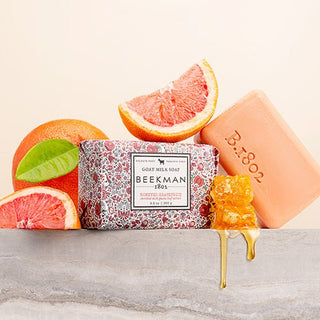 Goat Milk Bar Soap surrounded by grapefruit and honey. 