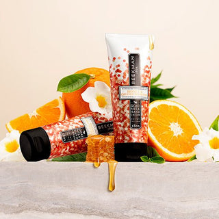Picture of Honey & Orange Blossom Hand Creams surrounded by oranges, dripping honey, and orange blossoms. 