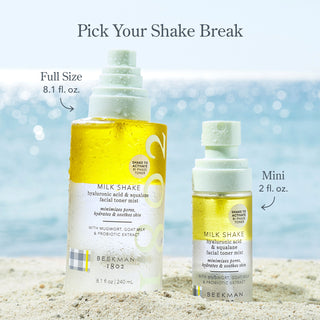 Beekman 1802 Full-size and Mini Milk Shake Toner mist on the beach in the sand in front of some water with the words "Pick you shake break" on top of the image.
