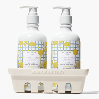 Beekman 1802's Almond Honey Cookie Caddy Set which show the hand & body wash and lotion inside a ceramic caddy, on a white background.