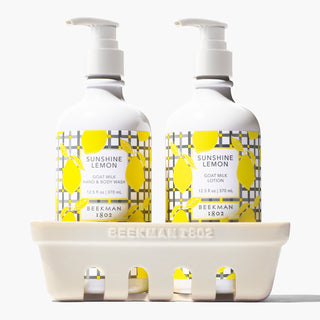 Beekman 1802's sunshine lemon hand and body wash and lotion in a ceramic caddy.