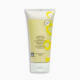 Tube of Beekman 1802's Sunshine Clay Body Mask laying on a light gray background.