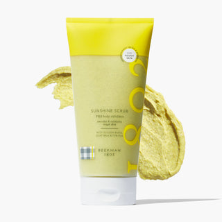 Tube of Beekman 1802's Sunshine Body Scrub 7.5% PHA Body Exfoliator in front of a texture swatch, on a white background. 