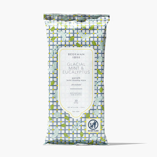 Package of Beekman 1802's Glacial Mint & Eucalyptus Face Wipes that is designed in gingham and leaves, standing on a white background.
