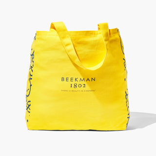 Back of Beekman 1802's 2023 Limited Edition Baby Goat Tote which says beekman 1802, "there's beauty in kindness" on the back on a white background.