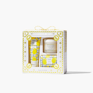 Box of Beekman 1802's Sunshine lemon Bodycare Gift Set, which shows the hand cream, mini whipped body cream, and travel sized bar soap on the front of the box, on a white background.