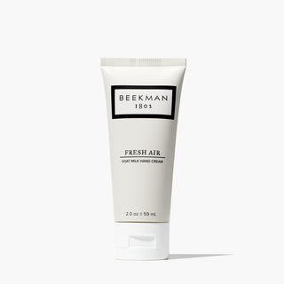 Tube of Beekman 1802's mini Fresh Air Hand Cream with white cap, standing on a white background.