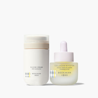 Bottle of Beekman 1802's Jumbo Bloom Cream Daily Moisturizer and Collagen Booster electric Daisy & Peptide Firming Serum standing next to each other on a white background.