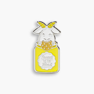 Beekman 1802's Sweet to be Kind Goatie Enamel Pin, which shows goatie peeking out of yellow cookie jar while holding a cookie, and the words "sweet to be kind" labeled on the jar, on a light grey background.
