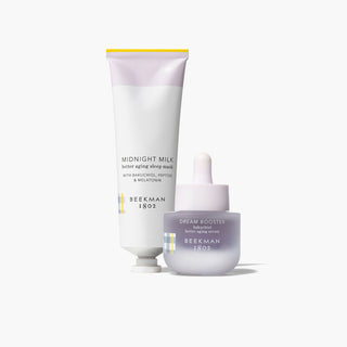 Products that come in Beekman 1802's Sweet Dreams Better Aging Gift Set which includes midnight milk better aging sleep mask, and dream booster bakuchiol better aging serum standing next to each other, on a white background.