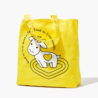 Beekman 1802's World Kindness Day Goat Tote in the sunshine yellow color with a white cartoon goatie on the front on a white background. 