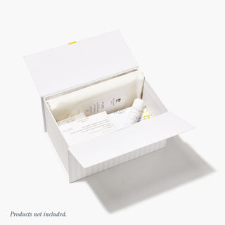 Opened Beekman 1802 white gift box on a white background, showing Beekman 1802 products placed inside the box.