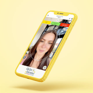 Cell phone on yellow background showing the screen of My Skin Biome facial scanner