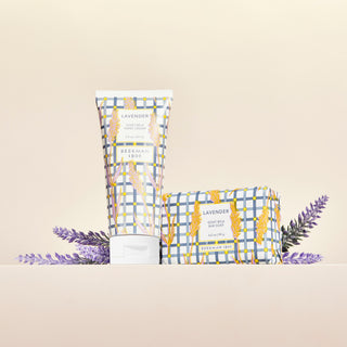 2oz Lavender Hand Cream and 3. oz lavender bar soap in front of lavender flowers.