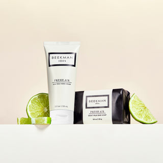 Fresh air 2 oz hand cream and 3.5 oz bar soap surrounded by sliced limes.