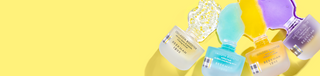 4 Bottles of Beekman 1802's Booster Serums which includes Collagen, Smooth, Golden, and Dream, on the far right of the image, and are all tipped over with product spilling out on yellow background. 