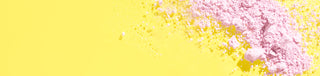 Image of pink Calamine ingredient in powder form spread across a yellow background to the right of the image.