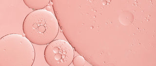 Up close shot of PHA ingredient colored pink in liquid form with small bubbles formed. 