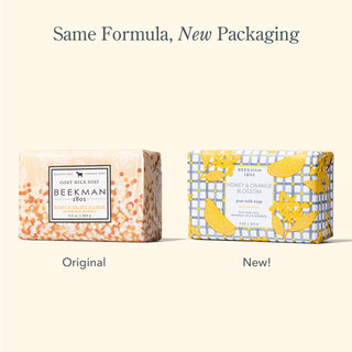 Side by side image of two of Beekman 1802's honey & orange blossom bar soaps, with the one on the left in the original packaging, and one on the right in the new packaging, with the words "same formula, new packaging," on top of the image.