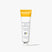 White tube of Beekman 1802's Mushroom Milk Better Aging Eye Cream that is yellow on the sealed end of the tube, standing on a white background.