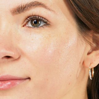 Up close shot of side of model's face after using Beekman 1802's Oh! Mega Milk Facial oil, revealing moisturized skin.