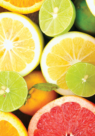 Up close shot of sliced up lemons, oranges, limes, and grapefruits all pictured together. 