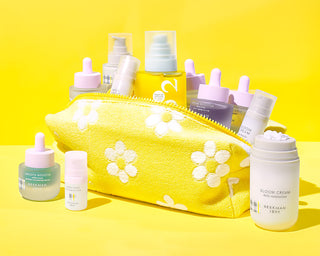 Skincare set inside and outside yellow with white flowers dopp bag on yellow background