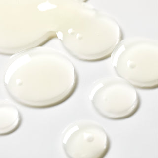 Up close texture shot of Beekman 1802's Vegan Goat Milk™ Pore Minimizing Facial Toner in the shape of little dots on a white background. 