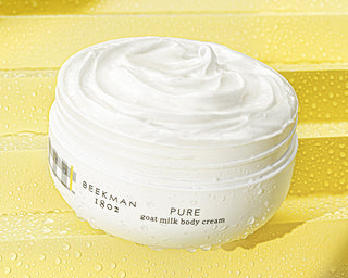Pure Goat Milk Whipped Body Cream white jar open showing goop texture on yellow background