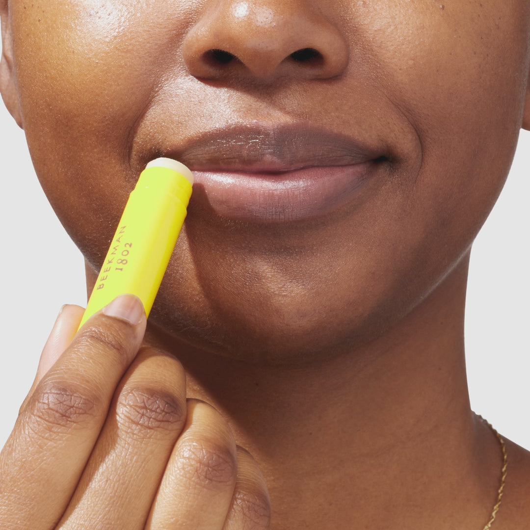 An up close video of a model applying the beekman 1802 lavender lip balm to her lips.