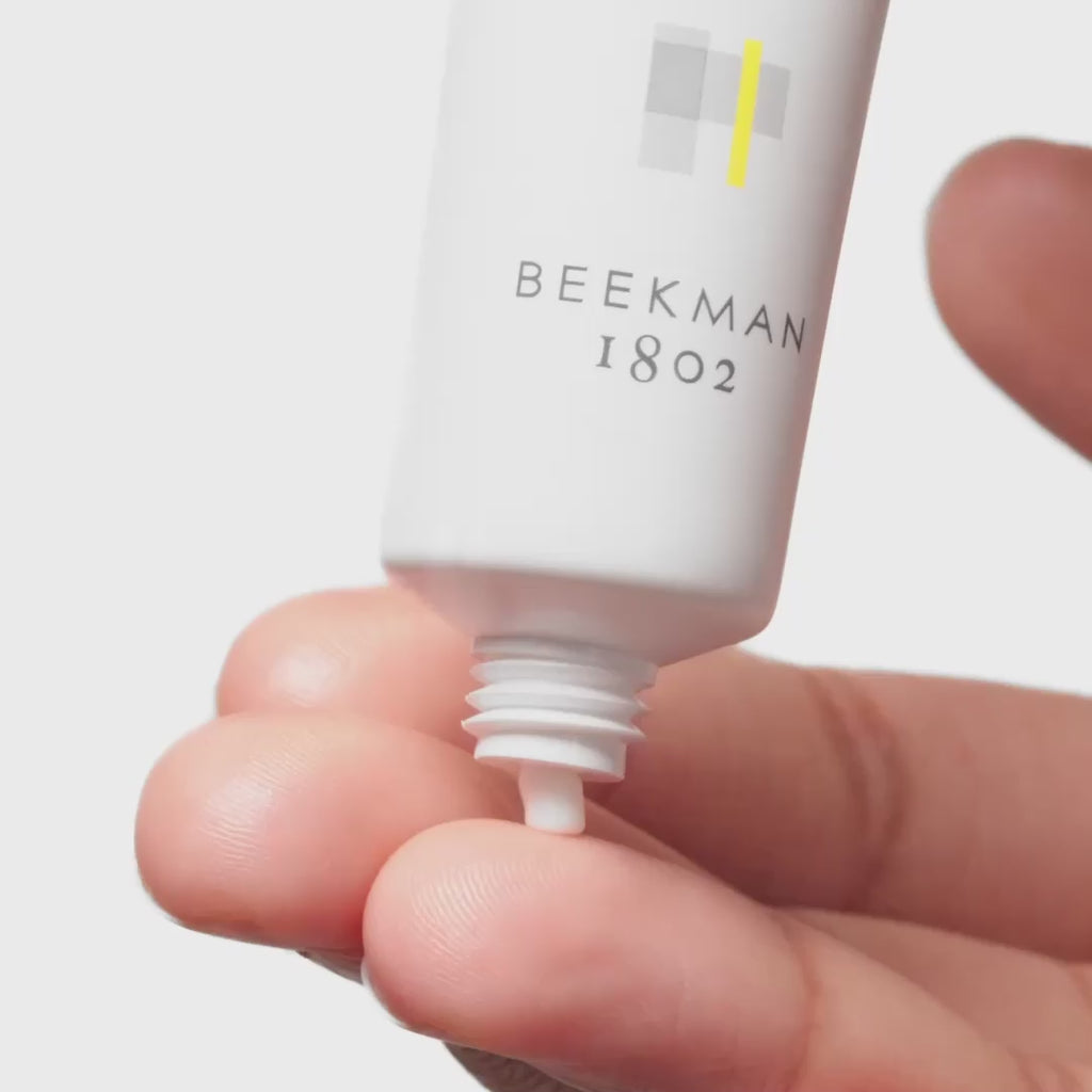Up close video of model applying Beekman 1802 Mushroom Milk Better Aging Eye Cream to their finger tip and applying it under and around their eyes while smiling at the camera. 