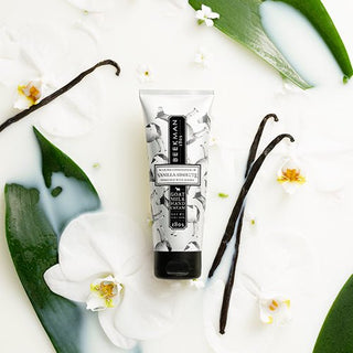 overhead shot of the vanilla absolute hand cream surrounded by milk spills, flowers, and vanilla beans.