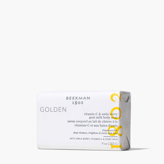 Beekman 1802 golden vitamin c and amla berry bar soap on grey background.