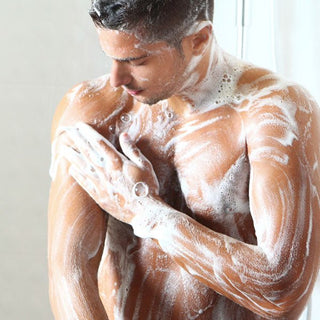 Man Using Bar Soap on His Bare Chest