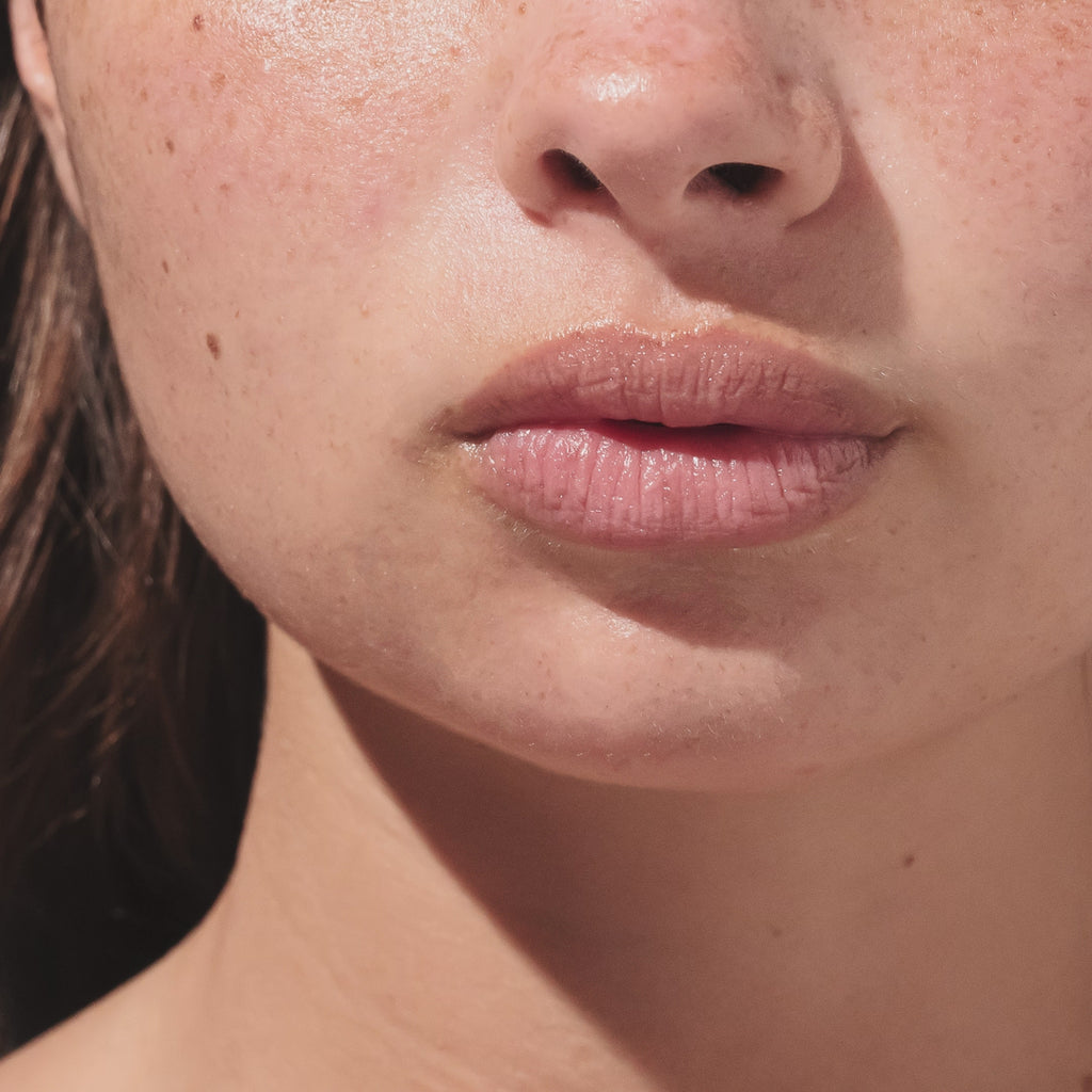 An up close video of a model applying the beekman 1802 Ylang ylang & Tuberose  lip balm to her lips.