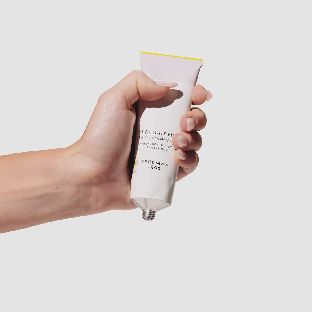 Video of hand squeezing the Midnight Milk and model applying it to their cheek afterwards.