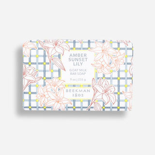 Beekman 1802 Amber sunset lily goat milk 9 oz bar soap wrapped in decorative packaging covered in lilies. 