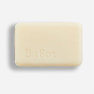 An image of an unwrapped Amaryllis Bouquet Bar Soap with the words B.1802 inscribed on the front of it.