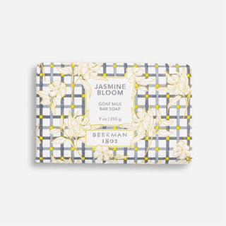 Bar of Beekman 1802's Jasmine Bloom Goat Milk Soap on a grey background.