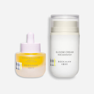beekman 1802 golden booster and full sized bloom cream on a grey background 
