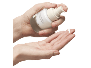  Hands Using a bottle of Beekman 1802's Milk Primer SPF 35 2-in-1 Daily Defense Sunscreen & Makeup Perfecter.